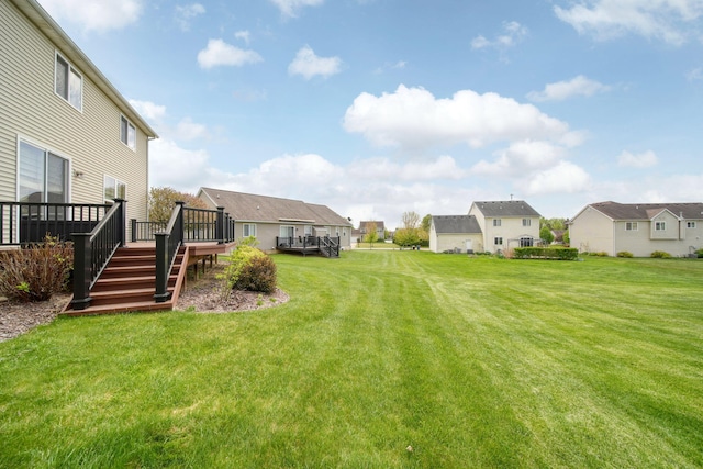 510 Edward J St, Clinton, MI 49236 - view of green lawn with a residential view, a wooden deck, and stairway