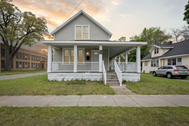 602 Ada Ave, Muskegon, MI 49442 - view of front of house featuring covered porch and a yard