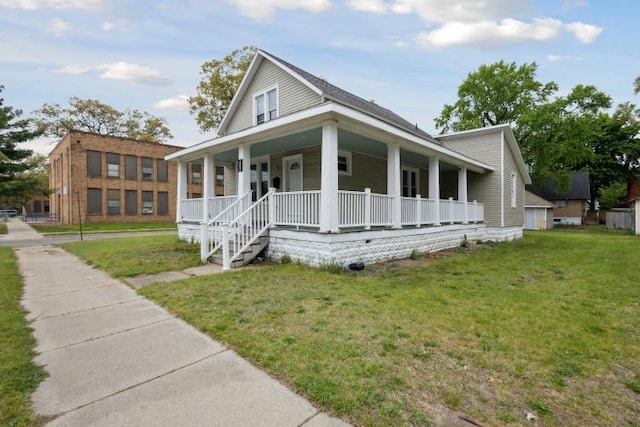 602 Ada Ave, Muskegon, MI 49442 - farmhouse featuring a porch and a front lawn