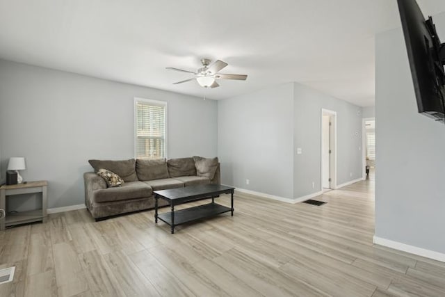 602 Ada Ave, Muskegon, MI 49442 - living area with ceiling fan, light wood finished floors, and baseboards