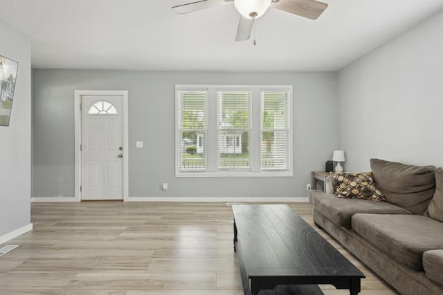 602 Ada Ave, Muskegon, MI 49442 - living room with a ceiling fan, light wood finished floors, and baseboards