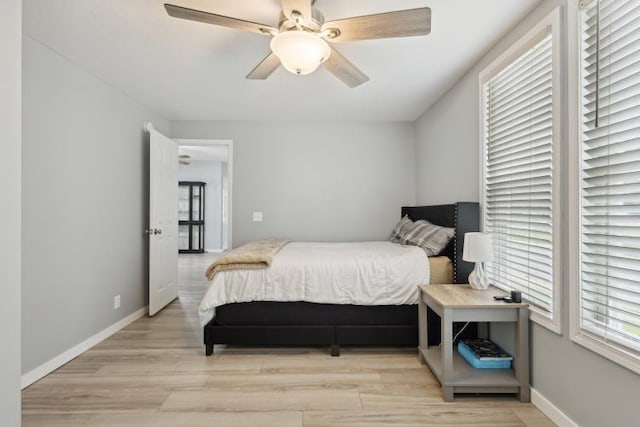 602 Ada Ave, Muskegon, MI 49442 - bedroom with light wood-type flooring, baseboards, and ceiling fan