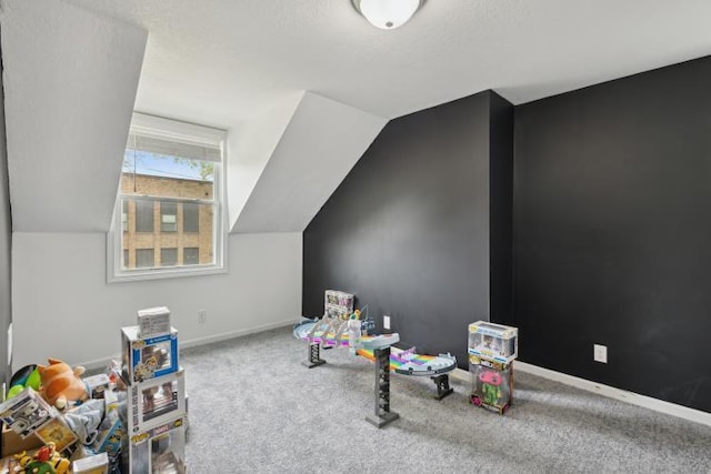 602 Ada Ave, Muskegon, MI 49442 - recreation room with lofted ceiling, baseboards, and carpet