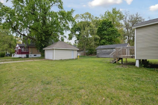 602 Ada Ave, Muskegon, MI 49442 - view of green lawn with a garage, an outdoor structure, and a wooden deck