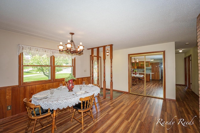 12498 Daling Ct NW, Grand Rapids, MI 49534 - dining space with a chandelier, wood finished floors, wainscoting, and wood walls