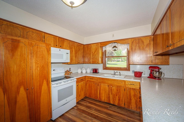 12498 Daling Ct NW, Grand Rapids, MI 49534 - kitchen with white appliances, a sink, light countertops, brown cabinetry, and backsplash