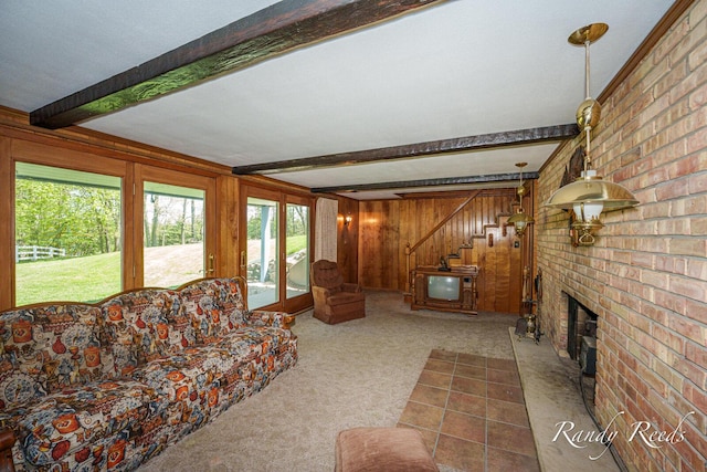 12498 Daling Ct NW, Grand Rapids, MI 49534 - carpeted living area featuring beam ceiling, healthy amount of natural light, wood walls, stairs, and a fireplace