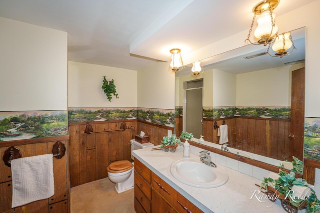12498 Daling Ct NW, Grand Rapids, MI 49534 - bathroom with wainscoting, vanity, an enclosed shower, and toilet