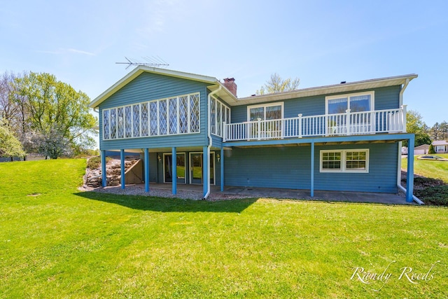 12498 Daling Ct NW, Grand Rapids, MI 49534 - back of house with a chimney, a yard, a sunroom, and a wooden deck