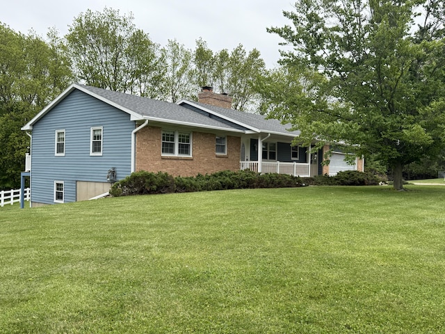 12498 Daling Ct NW, Grand Rapids, MI 49534 - view of front of property with a chimney, covered porch, roof with shingles, and brick siding