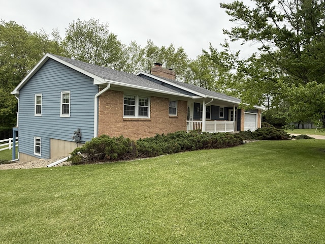 12498 Daling Ct NW, Grand Rapids, MI 49534 - view of front of house featuring a chimney, a front lawn, a garage, brick siding, and roof with shingles