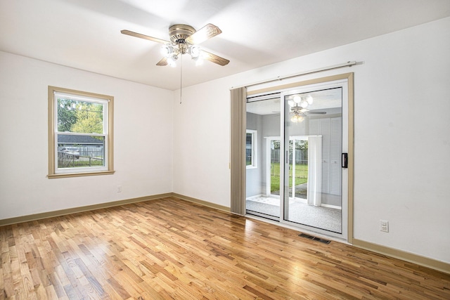 unfurnished room with ceiling fan, light wood-type flooring, and baseboards