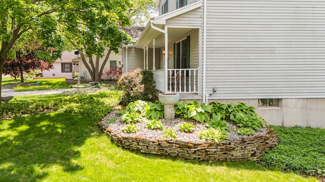 view of side of home with a yard