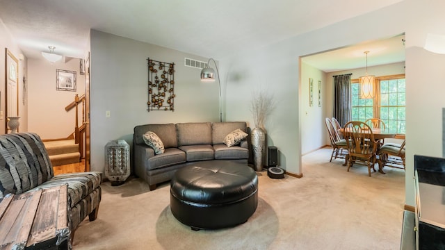 living room with light colored carpet and stairway