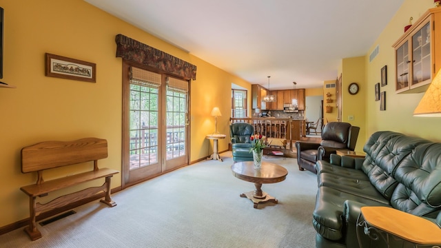 carpeted living room featuring baseboards
