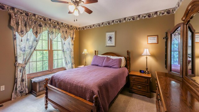 bedroom featuring light carpet and ceiling fan