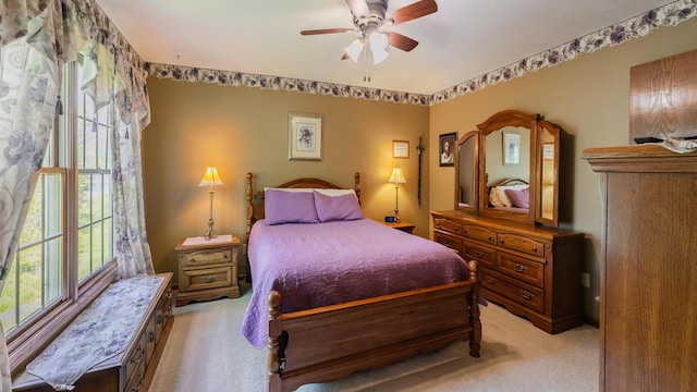 bedroom featuring light carpet and ceiling fan