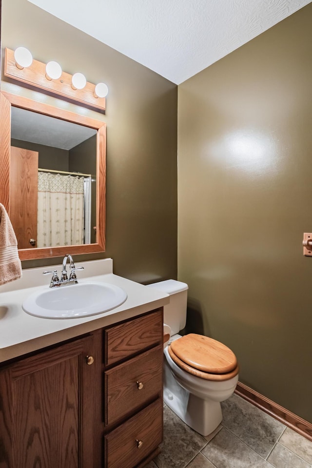 full bathroom featuring toilet, tile patterned floors, and vanity