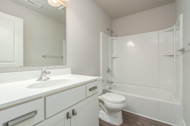 full bathroom featuring wood finished floors, vanity, toilet, and bathtub / shower combination