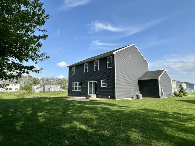 rear view of property featuring a yard, a patio area, and entry steps