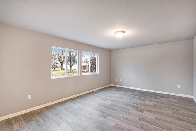 13686 Oasis Ave, Holland, MI 49424 - unfurnished room with wood finished floors and baseboards
