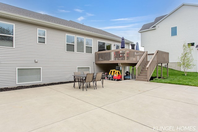 12745 Riverton Rd, Grand Haven, MI 49417 - rear view of house with a patio, a wooden deck, stairway, and outdoor dining area