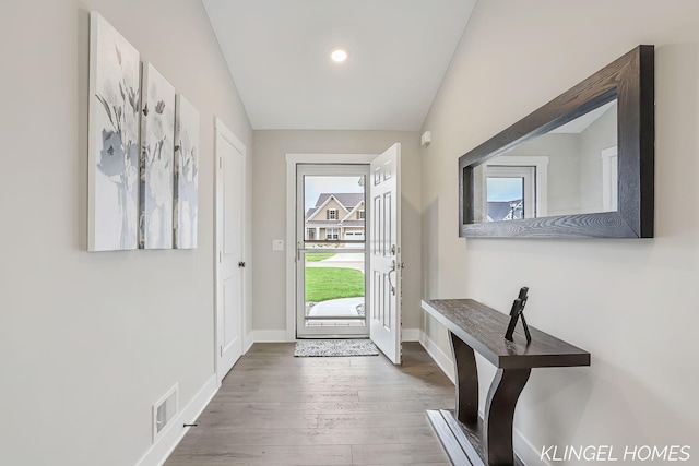 12745 Riverton Rd, Grand Haven, MI 49417 - entryway with wood finished floors, baseboards, vaulted ceiling, and recessed lighting