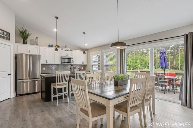 12745 Riverton Rd, Grand Haven, MI 49417 - dining space with light wood finished floors and vaulted ceiling