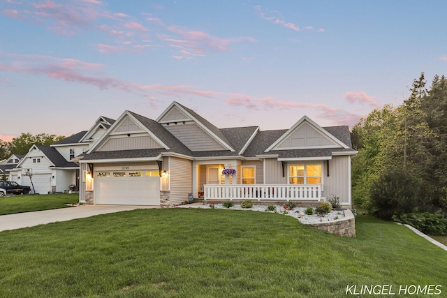 12745 Riverton Rd, Grand Haven, MI 49417 - view of front facade with board and batten siding, covered porch, a yard, concrete driveway, and an attached garage