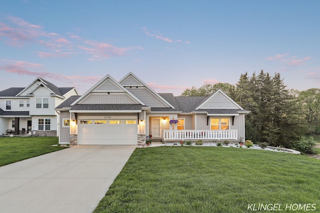 12745 Riverton Rd, Grand Haven, MI 49417 - craftsman house featuring board and batten siding, a lawn, an attached garage, driveway, and a porch