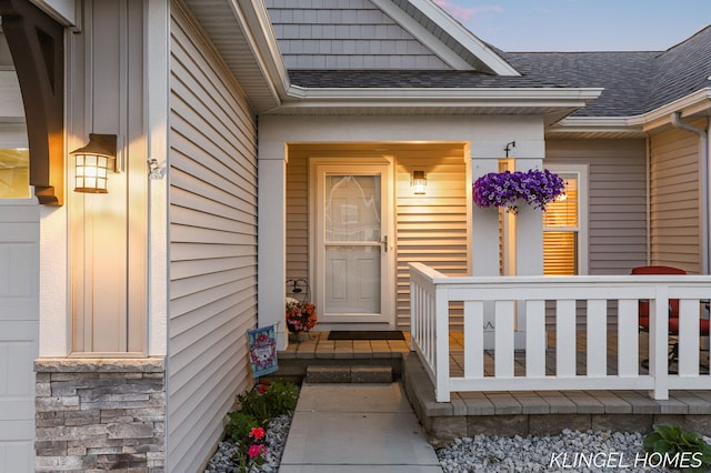 12745 Riverton Rd, Grand Haven, MI 49417 - view of exterior entry with a shingled roof