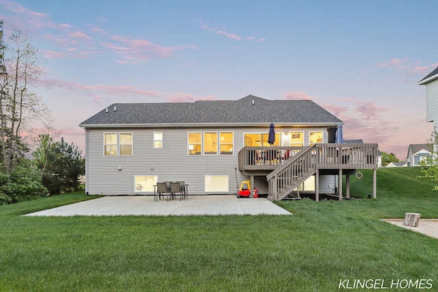 12745 Riverton Rd, Grand Haven, MI 49417 - back of property at dusk featuring a patio, a lawn, a deck, and a shingled roof