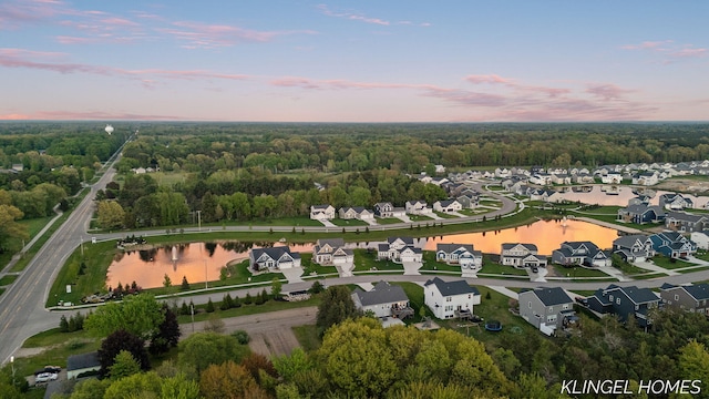 12745 Riverton Rd, Grand Haven, MI 49417 - aerial view at dusk of a residential view, a water view, and a view of trees