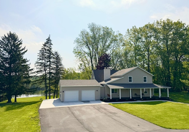 928 Lincoln St, Grand Rapids, MI 49534 - view of front of property featuring a garage, driveway, covered porch, a front yard, and a chimney