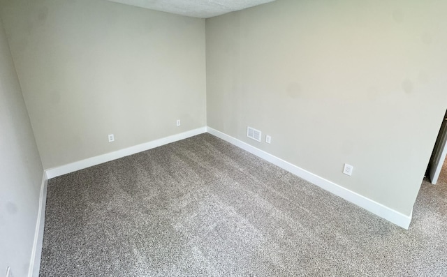 928 Lincoln St, Grand Rapids, MI 49534 - empty room featuring dark colored carpet and baseboards