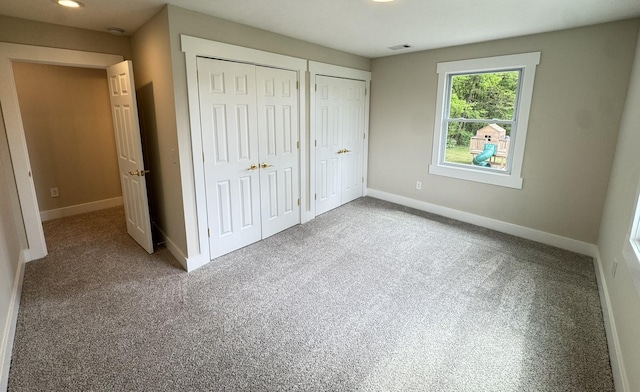 928 Lincoln St, Grand Rapids, MI 49534 - unfurnished bedroom featuring two closets, carpet floors, and baseboards