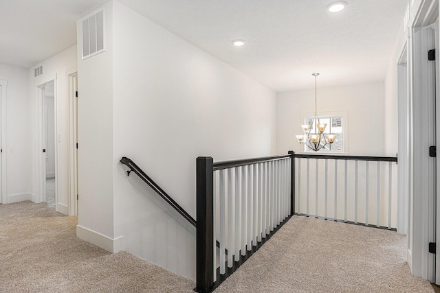 6182 Longhorn Trl, Stevensville, MI 49127 - hall featuring carpet floors, an upstairs landing, a chandelier, and recessed lighting