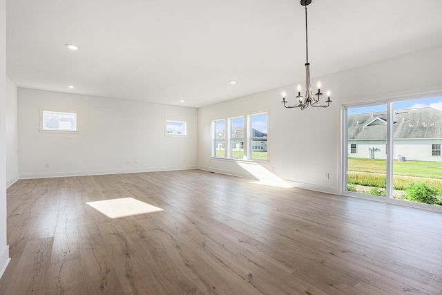 6182 Longhorn Trl, Stevensville, MI 49127 - unfurnished room featuring a chandelier, light wood-style flooring, healthy amount of natural light, and recessed lighting