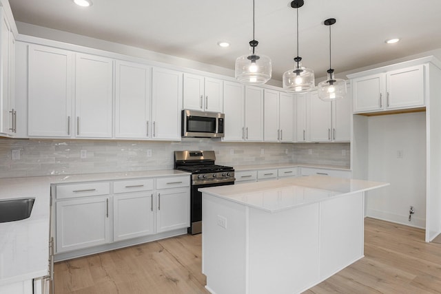 6182 Longhorn Trl, Stevensville, MI 49127 - kitchen with appliances with stainless steel finishes, light wood-style floors, decorative backsplash, white cabinets, and recessed lighting