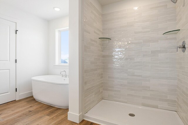 6182 Longhorn Trl, Stevensville, MI 49127 - full bath featuring wood finished floors, tiled shower, and a freestanding bath
