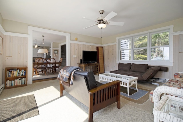 2177 S Lakeshore Dr, Ludington, MI 49431 - living room with wooden walls, ceiling fan, and carpet floors