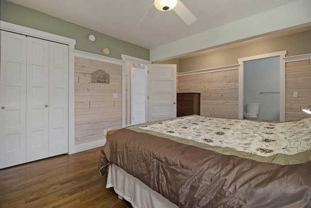 2177 S Lakeshore Dr, Ludington, MI 49431 - bedroom featuring dark wood-style floors, ensuite bath, wood walls, and a ceiling fan