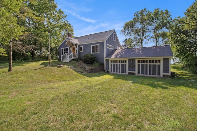 2177 S Lakeshore Dr, Ludington, MI 49431 - back of property featuring a chimney and a lawn