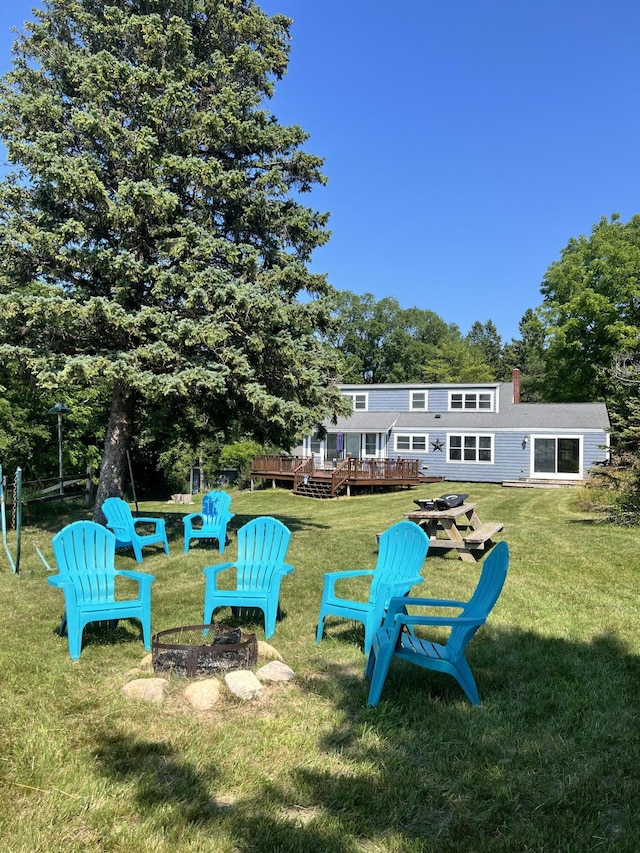 2177 S Lakeshore Dr, Ludington, MI 49431 - view of grassy yard with an outdoor fire pit and a wooden deck