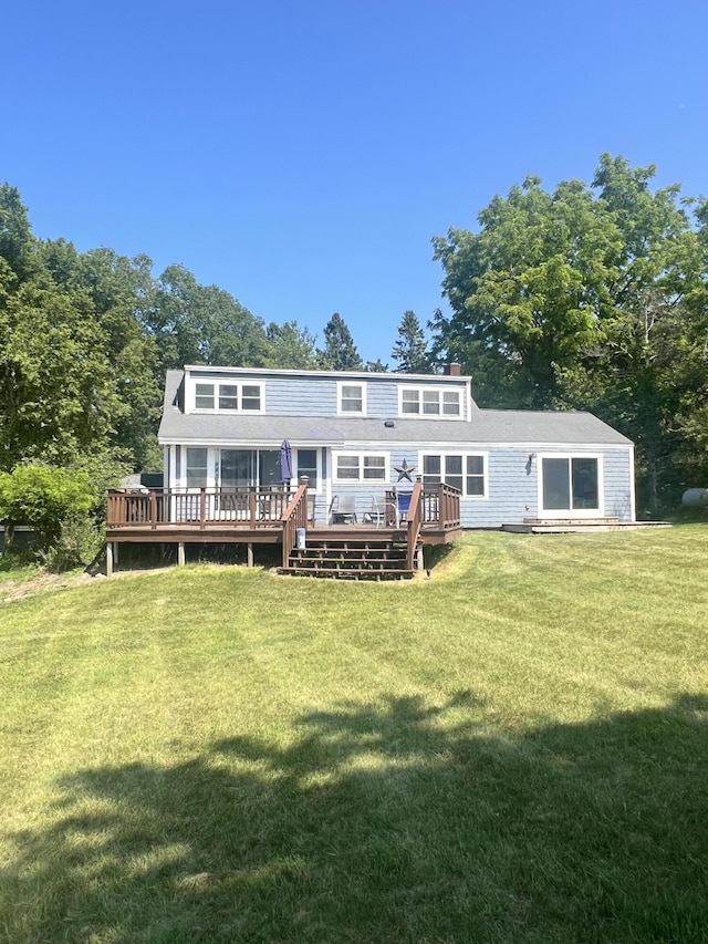 2177 S Lakeshore Dr, Ludington, MI 49431 - back of house featuring a deck, a lawn, and a chimney