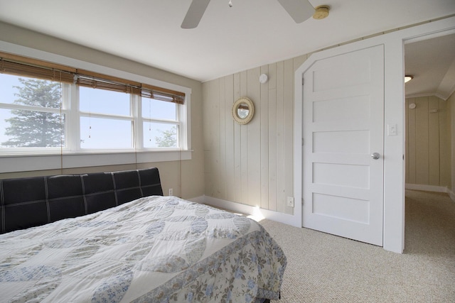 2177 S Lakeshore Dr, Ludington, MI 49431 - bedroom with carpet, wood walls, and a ceiling fan