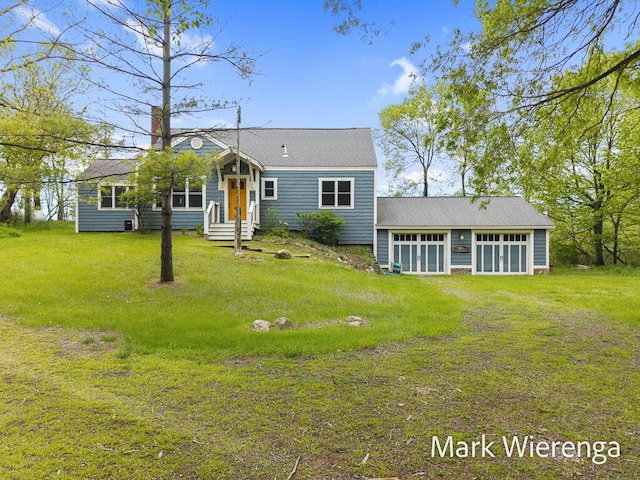 2177 S Lakeshore Dr, Ludington, MI 49431 - rear view of property featuring a chimney, a yard, and entry steps