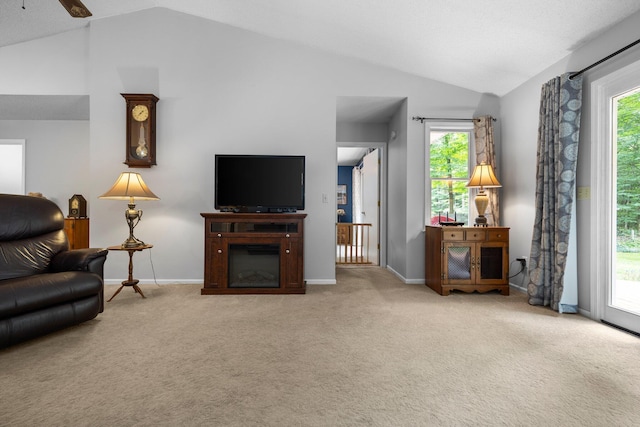 carpeted living room with vaulted ceiling, baseboards, healthy amount of natural light, and ceiling fan
