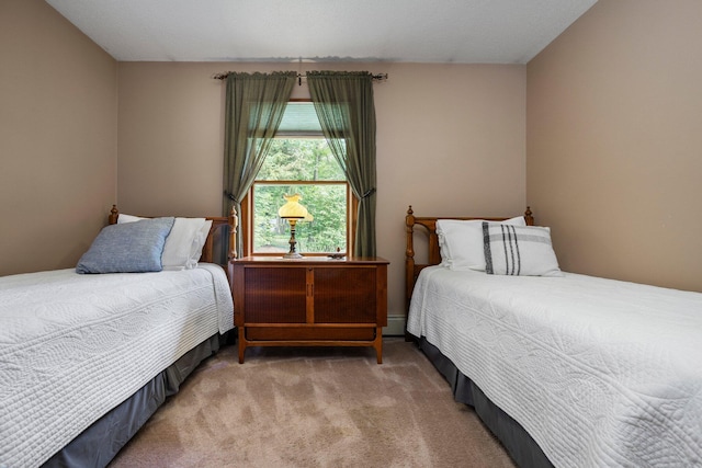 carpeted bedroom featuring baseboard heating