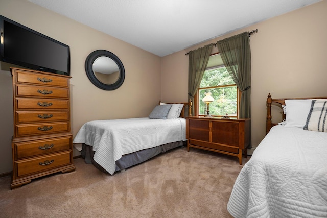 bedroom with light carpet, a baseboard heating unit, and vaulted ceiling